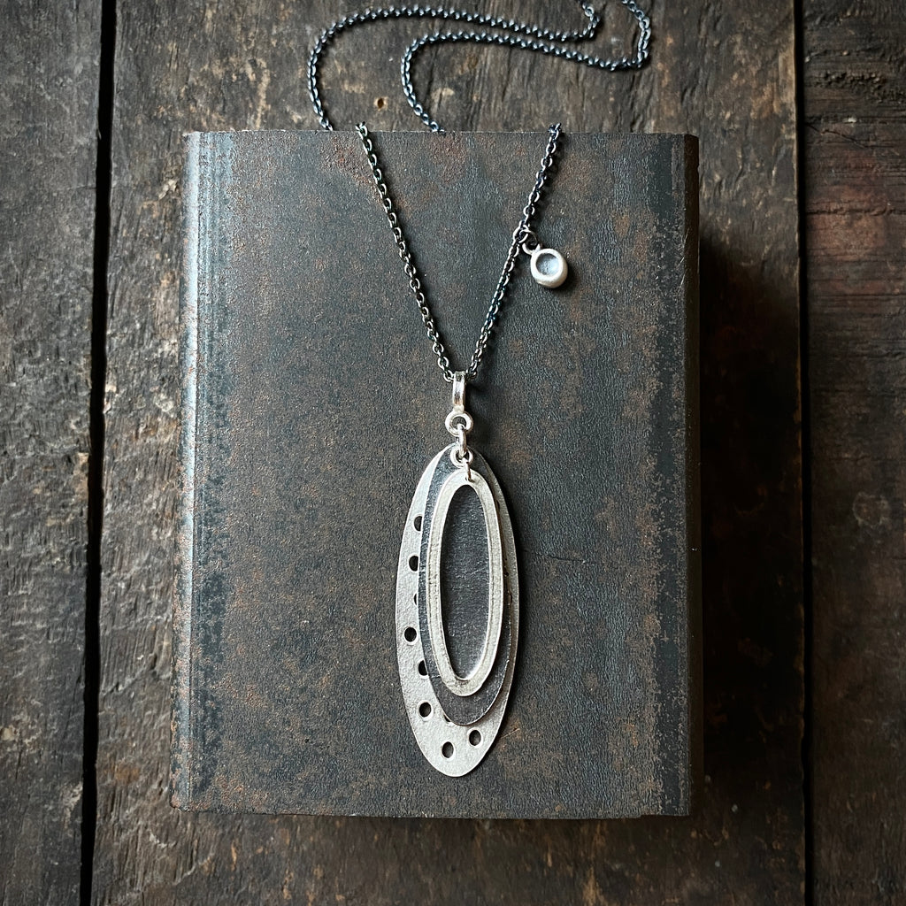 Foramina Pendant with Dot Charm